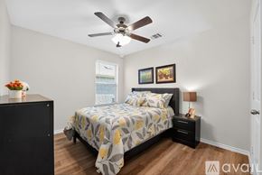 Lavon house for rent - A bedroom with a bed, nightstand, and a ceiling fan.