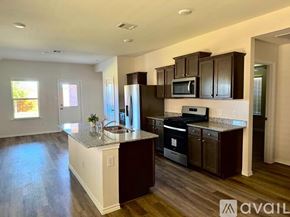 Lavon house for rent - A kitchen with dark brown cabinets and a white island.