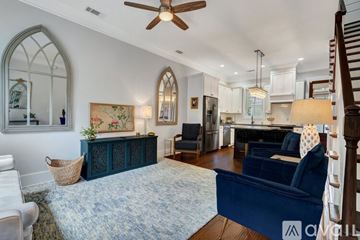 Savannah house for rent - A living room with a blue sofa and a fan.