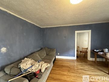 Lewiston apartment for rent - A living room with a grey couch and a wooden floor.