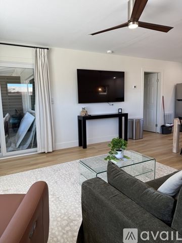 Venice apartment for rent - A living room with a grey couch and a glass coffee table.