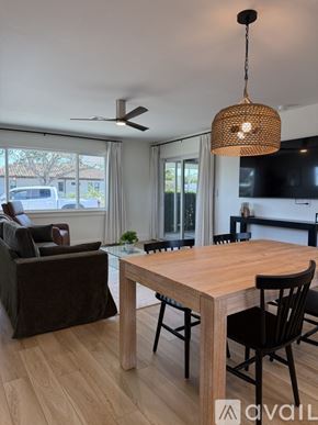 Venice apartment for rent - A modern dining room with a wooden table and chairs.