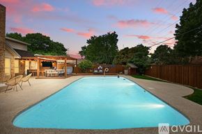 Haltom City house for rent - A backyard with a pool and a deck.