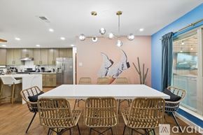 Haltom City house for rent - A modern kitchen with a dining table and chairs.