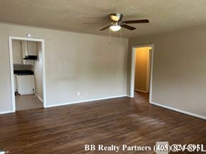 Tulsa apartment for rent - A room with a ceiling fan and wooden flooring is on the market with BB Realty Partners.