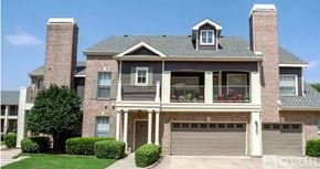 Carrollton apartment for rent - A large house with a grey roof and a balcony.