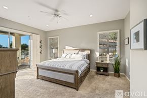 Scottsdale house for rent - A bedroom with a large bed and a ceiling fan.