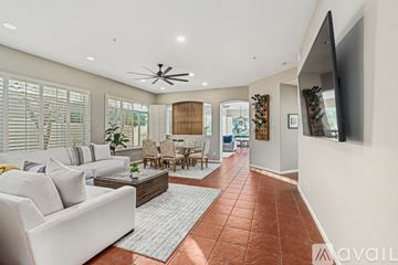 Scottsdale house for rent - A living room with a white couch and a ceiling fan.