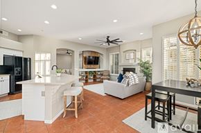 Scottsdale house for rent - A spacious kitchen with a bar area and a dining table with chairs.
