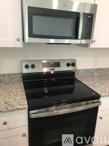Princeton apartment for rent - A kitchen with a black stove top oven and a silver microwave above it.