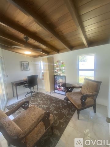 Lauderdale By The Sea house for rent - A living room with a brown chair and a brown rug.