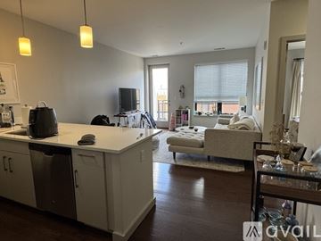 Brookline apartment for rent - A kitchen with white cabinets and a black dishwasher.