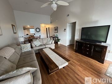 Punta Gorda condo for rent - A living room with a grey couch and a wooden floor.
