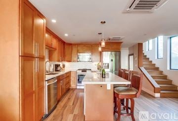 San Diego house for rent - A kitchen with wooden cabinets and a white island.