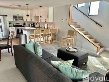 San Diego house for rent - A living room with a grey couch and wooden chairs.