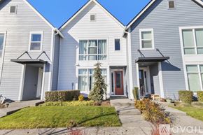 Hillsboro townhouse for rent - A two-story house with a garage door.