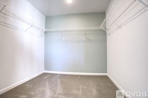 Hillsboro townhouse for rent - A sparsely furnished room with a carpeted floor and white walls.