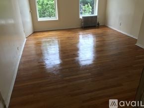 Brooklyn townhouse for rent - A room with wooden flooring and a window.