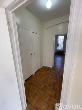 Brooklyn townhouse for rent - A hallway with wooden floors and white walls.