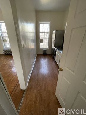 Brooklyn townhouse for rent - A hallway with wood floors and white walls.