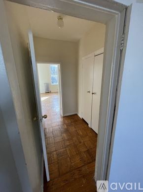 Brooklyn townhouse for rent - A hallway with a wooden floor and white walls.