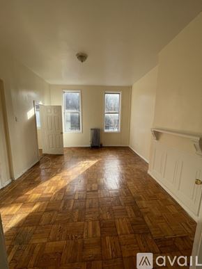 Brooklyn townhouse for rent - A room with wooden flooring and white walls.