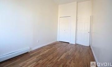 Brooklyn townhouse for rent - A room with wooden floors and two white doors.