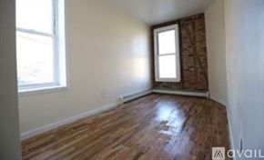 Brooklyn townhouse for rent - A room with wooden flooring and a window.
