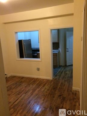 Brooklyn townhouse for rent - A room with wooden floors and a window.