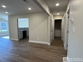 Knoxville townhouse for rent - A spacious room with wood flooring and a large window.