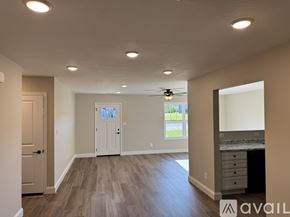 Knoxville townhouse for rent - A spacious room with a door, a window, and a ceiling fan.
