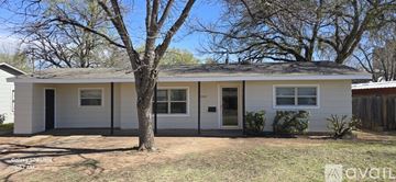 Wichita Falls apartment for rent - A small white house with a tree in front.