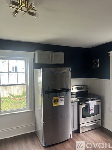 Salem apartment for rent - A kitchen with white cabinets and a window.