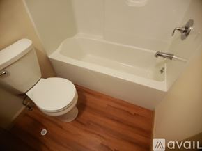 Frostburg apartment for rent - A white toilet sits next to a bathtub in a bathroom.