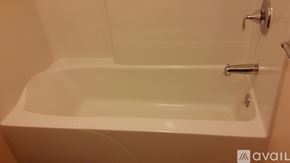 Frostburg apartment for rent - A white bathtub with a silver faucet and handle.