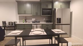 Idaho Falls house for rent - A kitchen with a table set for two in front of it.