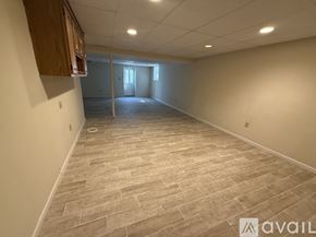 Severna Park apartment for rent - A spacious room with a tiled floor and a doorway leading to another room.