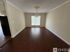 Severna Park apartment for rent - A living room with a white sofa, a grey armchair, and a glass coffee table.