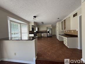 Severna Park apartment for rent - A dining room with a chandelier, a table with chairs, and a television.