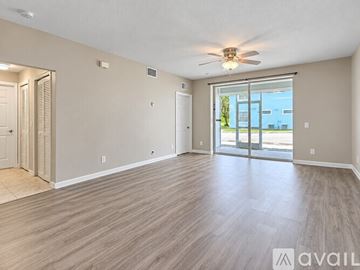 Cape Coral apartment for rent - A kitchen with white cabinets and a white island with a refrigerator and sink.