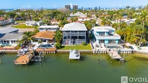 St. Pete Beach apartment for rent - A room with wooden flooring and a ceiling fan.
