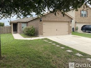San Antonio house for rent - A house with a brown garage door is surrounded by a green lawn.