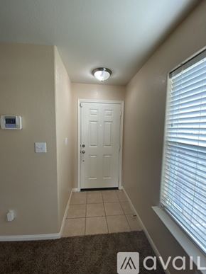 San Antonio house for rent - A hallway with a door, a window with blinds, and a light on the ceiling.