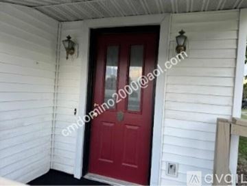 Terre Haute apartment for rent - A kitchen with white cabinets and a checkered wallpapered wall.