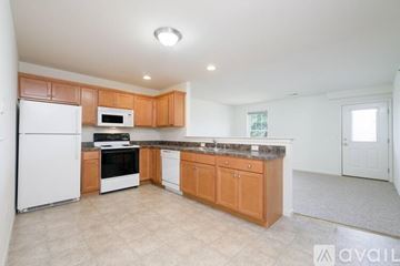 Millersville apartment for rent - A kitchen with white appliances and wooden cabinets.