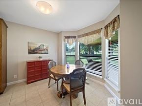 Broken Arrow house for rent - A dining room with a table, chairs, and a painting on the wall.
