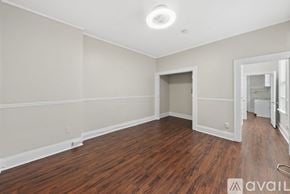 Tampa apartment for rent - A room with wooden floors and a white ceiling with a light fixture.