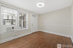 Tampa apartment for rent - A room with a ceiling fan and two windows.