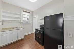 Tampa apartment for rent - A room with a wooden floor and a ceiling fan.