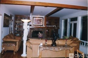 Mercer Island house for rent - A living room with a couch, chair, and fireplace.